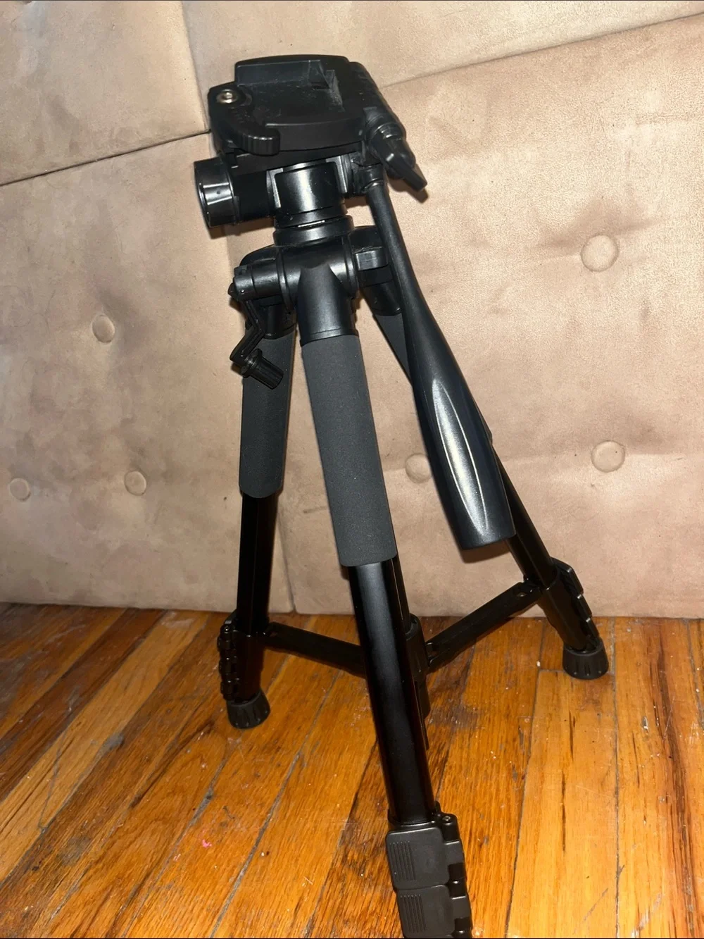 Black Camera Tripod with Foam Grip and Adjustable Head